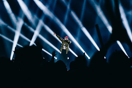 person standing on stage while performing thumbnail