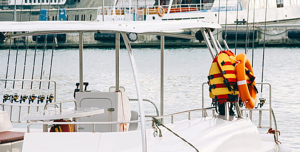 Photo of White Boat With Life Vest on Side thumbnail