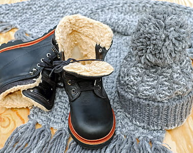 pair of black leather work boots and gray crochet beanie thumbnail