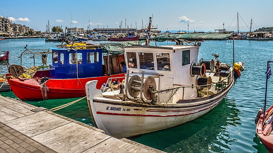 two boats on body of water beside dock thumbnail