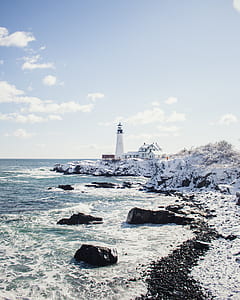 white concrete lighthouse near sea under white clouds at daytime thumbnail