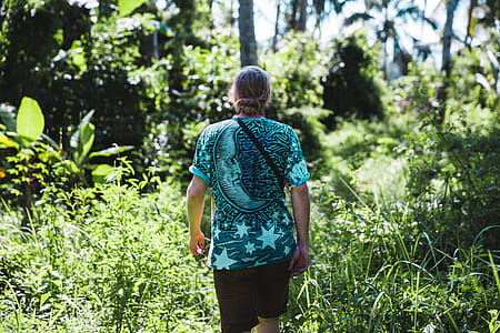 A hiker in casuals walking in the forest thumbnail