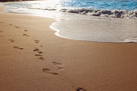 footsteps on sand near shore thumbnail