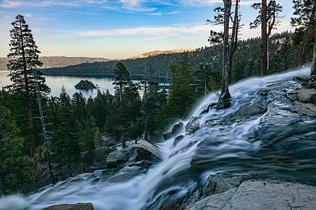 time lapse photography of waterfalls surrounded with pine trees thumbnail