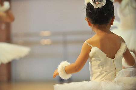shallow focus photograph of child in white tutu dress thumbnail
