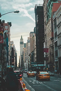 group of people in front of building under cloudy sky thumbnail
