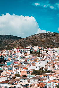 brown and white concrete houses under blus sky thumbnail