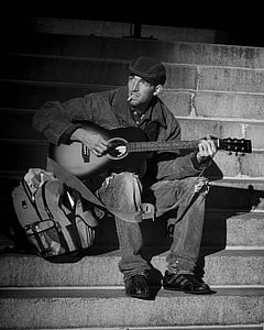 man in black denim jacket playing guitar thumbnail
