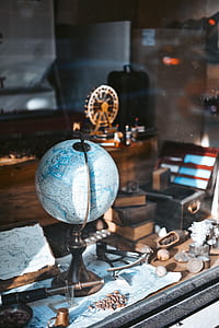 desk focus photography of desk globe on world map thumbnail