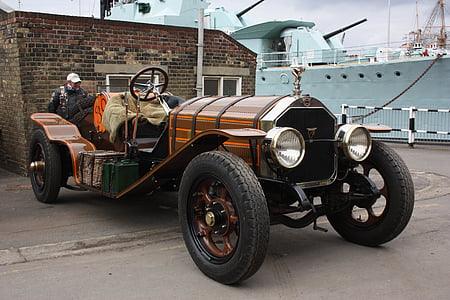 orange, silver, and black roadster during daytime thumbnail