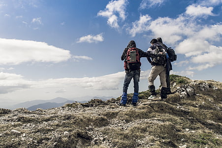 three man climbing mountain at daytime thumbnail