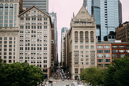 gray concrete road in the middle of beige concrete buildings thumbnail