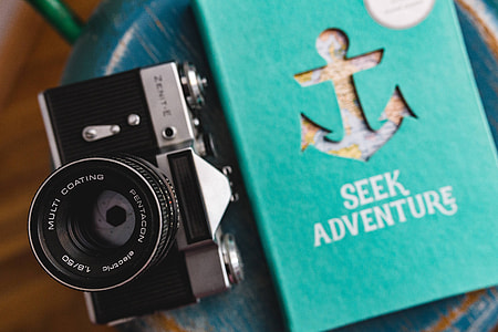 Blue notebooks and a camera on a blue wooden stool thumbnail