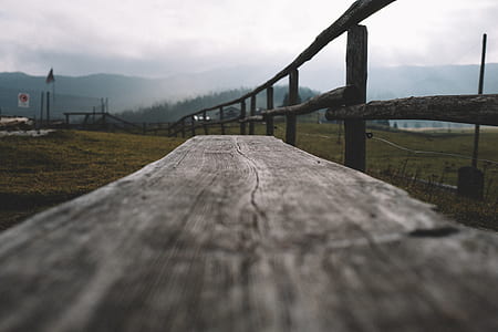 brown wooden fence on green grass field thumbnail