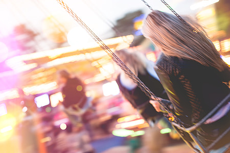 Young Girl Enjoying Crazy Ride on Swing Carousel thumbnail
