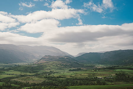landscape photography of green leafed trees under cloudy sky during daytime thumbnail
