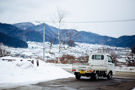 white delivery truck beside snow thumbnail