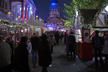 group of people standing near buildings at nighttime thumbnail