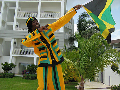 Man holding Jamaican Celebration Flag thumbnail
