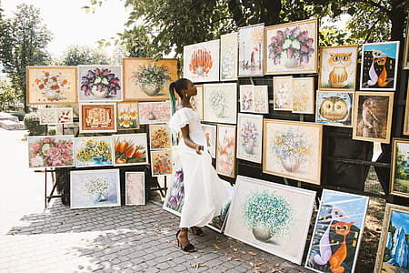 Woman Looking on Flower Painting thumbnail