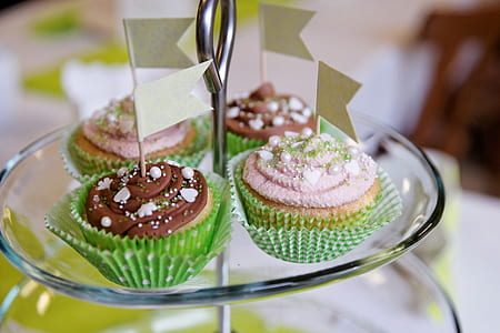 four cupcakes on clear glass 2-tier stand thumbnail