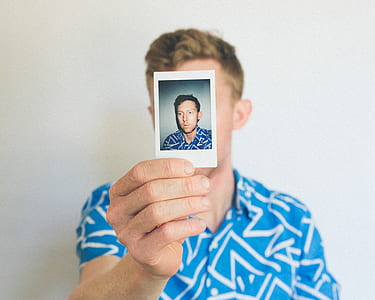 man holding photo thumbnail