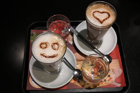 two glass of latte on white ceramic saucer thumbnail