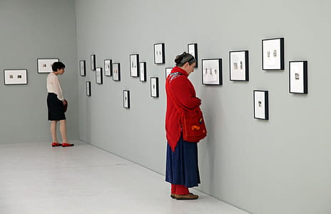 two women inside gray painted gallery thumbnail