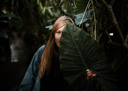 woman holding large green leaf plant thumbnail