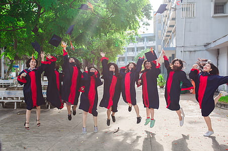 women wearing black and pink academic regalia thumbnail