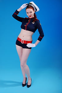 woman wearing a blue crop-top long-sleeved shirt and black shorts thumbnail