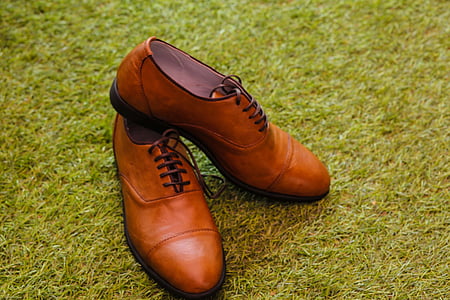 pair of brown leather dress shoes on grass thumbnail