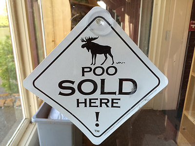 hanged white and black Poo sold here signage thumbnail