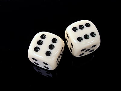two white-and-black dice on black surface thumbnail