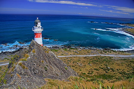 white and orange lighthouse photo on beach thumbnail
