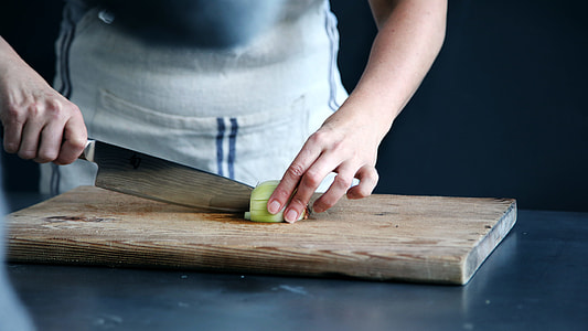 silver kitchen knife and brown wooden chopping board thumbnail