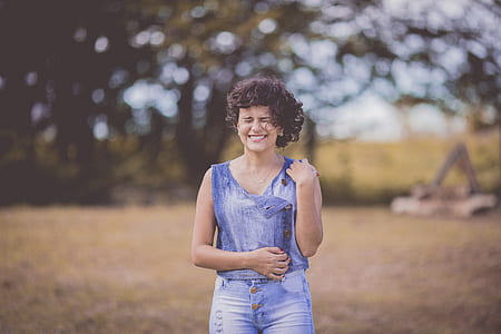 In Distance Woman Wearing Blue Scoop-neck Sleeveless Top and Blue Denim Bottoms thumbnail