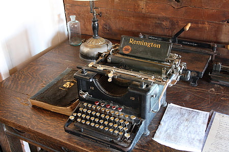 black Remington typewriter beside white printer paper thumbnail
