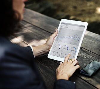 woman sitting while holding tablet thumbnail