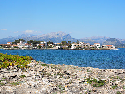 white concrete buildings near body of water during daytime thumbnail