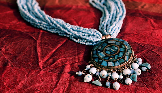 beaded blue stone necklace on red cloth thumbnail