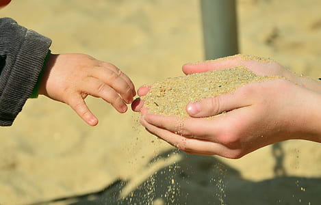 brown sand on person's hand thumbnail