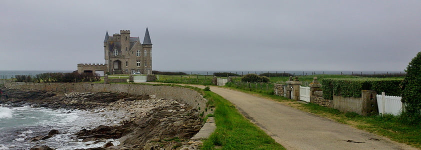 brown and gray castle near body of water at daytime thumbnail