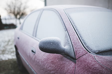 maroon sedan covered with snow thumbnail