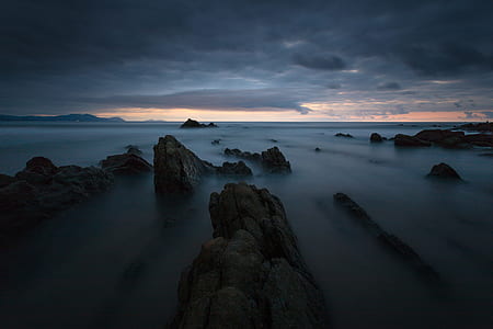 body of water surrounded with rocks thumbnail