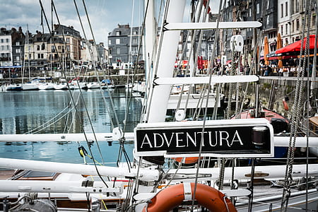 white Adventura boat parked beside dock thumbnail