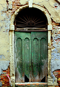 closed green wooden door with arch on top thumbnail
