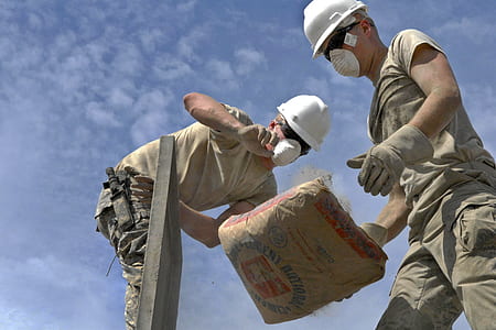two person dropping a sack of cement thumbnail