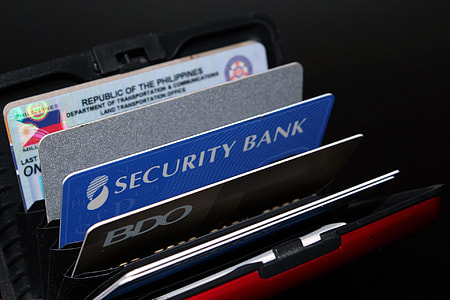 assorted ATM card in black leather wallet in close-up photography thumbnail
