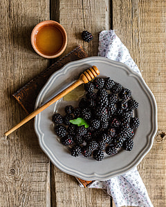 black berries on white ceramic plate on brown table top thumbnail